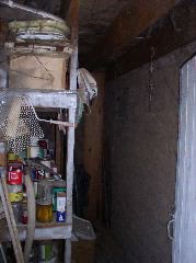 Inside the right half of the adobe shed